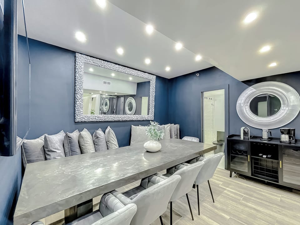 Full-size kitchen with brand new state-of-art Samsung stove, convection oven, air fryer, island bar with in-kitchen dining, entertaining 70-inch smart TV in the dining room, 50-inch in kitchen, stone dining table for up to 12 persons & bar seating.