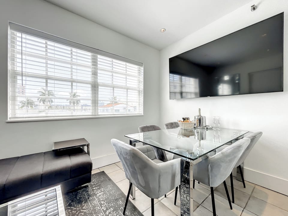 The 7th bedroom or Livingroom, depending on the bed set up. Bright living room with a large 75-in Smart TV and oversized window with a partial city view tucked away from any street noise in the heart of South Beach's Entertaining Art Deco District. 