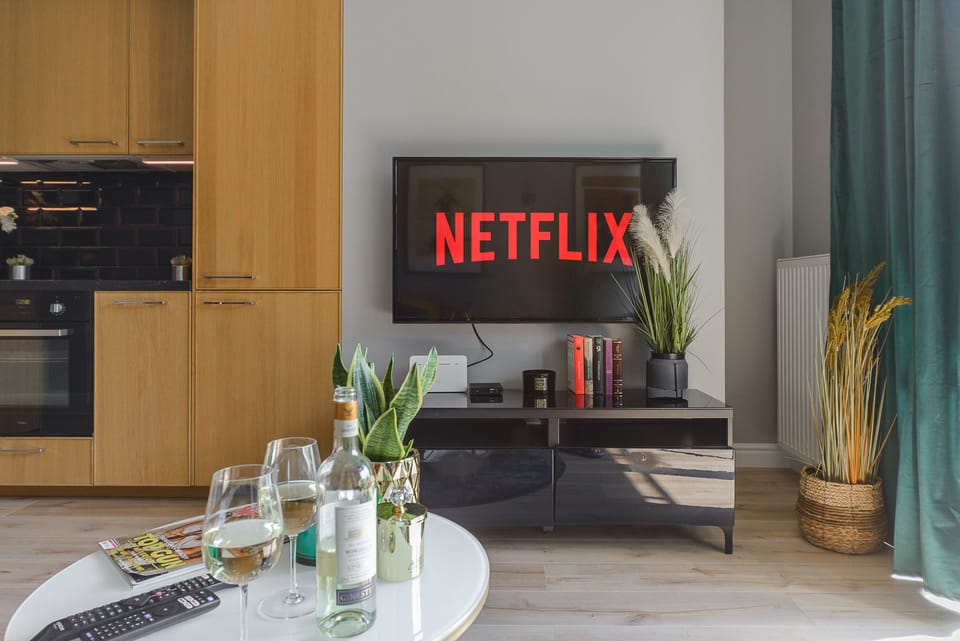 Deluxe Apartment | Living area | 40-inch Smart TV with cable channels