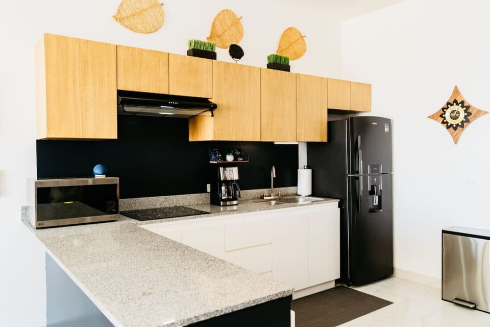 The open‑concept kitchen is cozy and efficient, perfect for whipping up breakfasts, light meals, or snacks on the go.