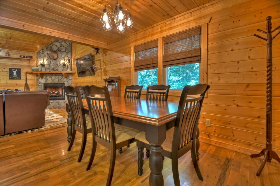 Dinning room table leading into family room w/ gas fireplace