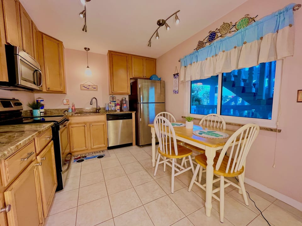 fully stocked kitchen with all cooking utensils, silverware, wine glasses, k-cup