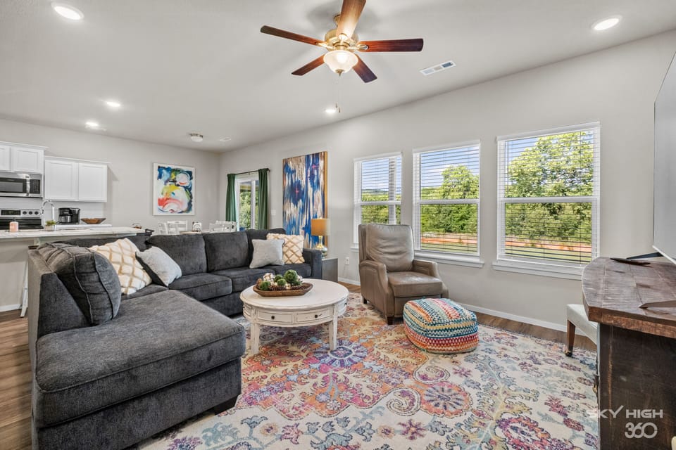 Living room with tall ceilings, lots of light and open concept!