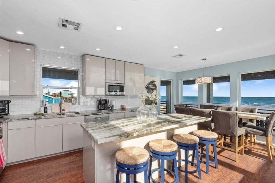 Gourmet kitchen with large island, bar seating, and stainless steel appliances