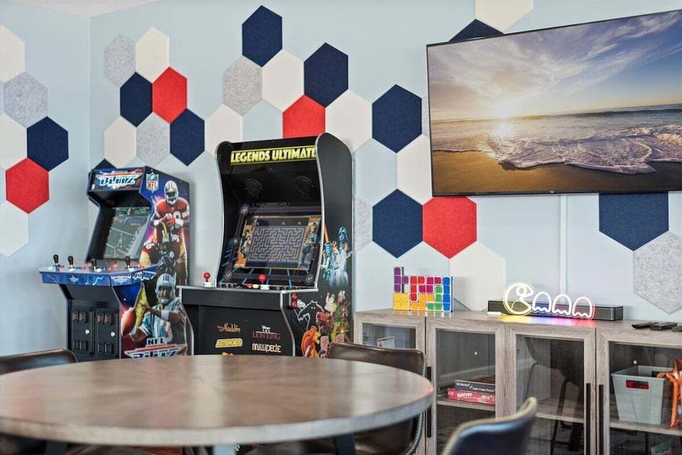 Arcade game area with multiple machines and vibrant wall décor