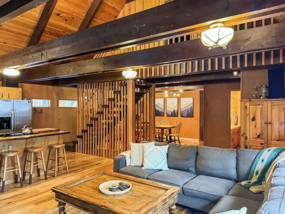 Living room with huge vaulted ceilings and architectural features, large brand new couch