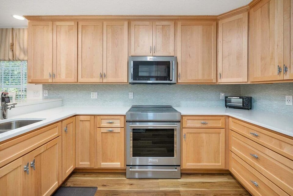 Wood kitchen with stainless range and tile backsplash