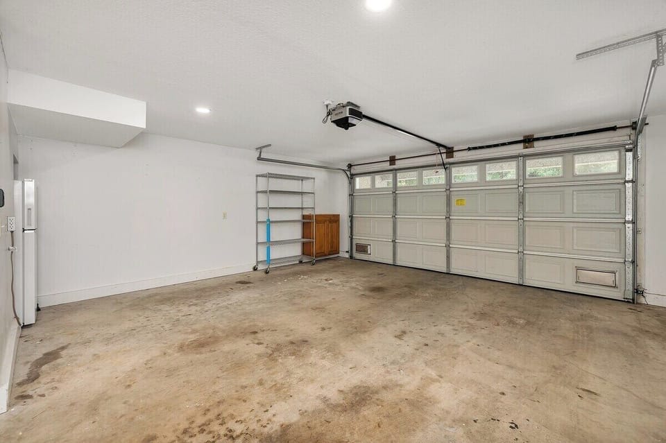 Garage with shelving and two-car garage doors