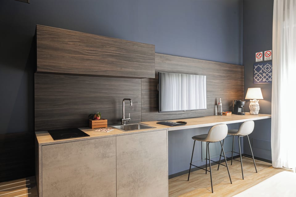 Deluxe Room | Private kitchen | Fridge, espresso maker, coffee/tea maker, cleaning supplies