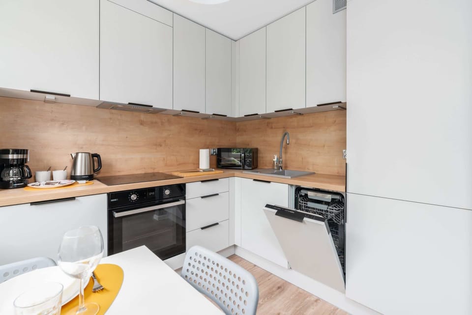 A closer perspective of the kitchen, showcasing modern appliances and stylish finishes.

