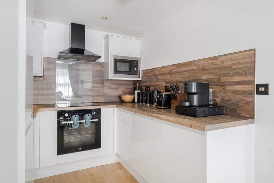 Full Kitchen | Savor the luxury of a fully-equipped kitchen, designed for any duration of stay. Revel in modern conveniences such as a washer, dryer, dishwasher, nespresso machine, and a fresh water dispenser, ensuring your comfort.