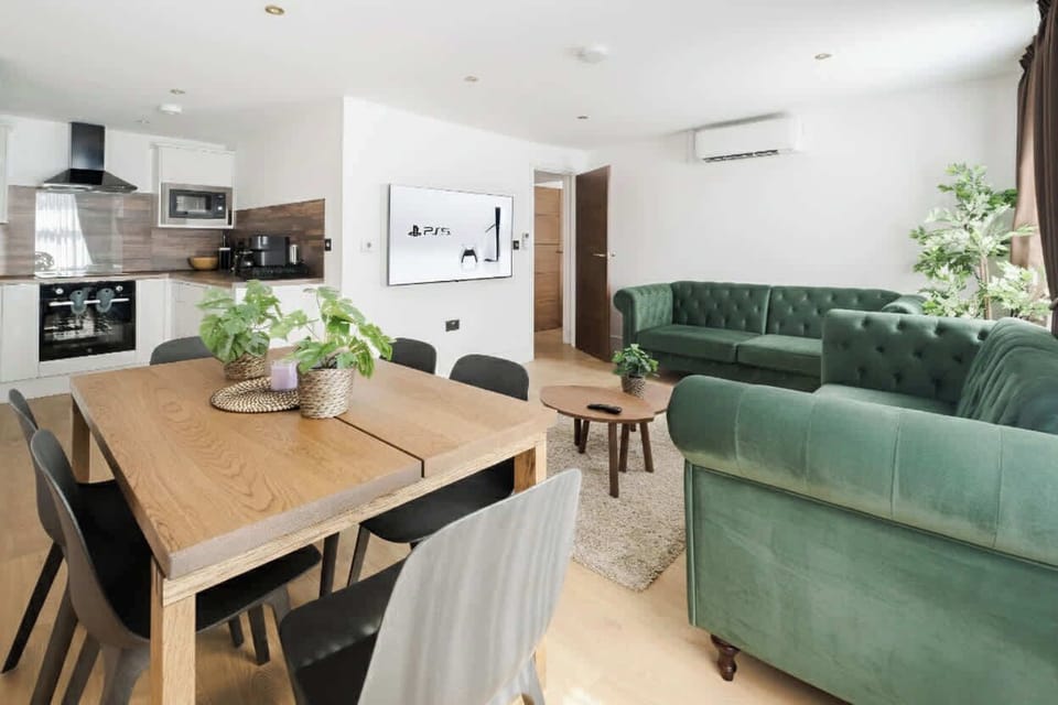 Living Room | Unwind in pure luxury within a beautifully designed living room, boasting wooden panels, and ambient LED lighting. This generously spacious sanctuary is graced with a 65-inch smart TV and furnished with air conditioning.
