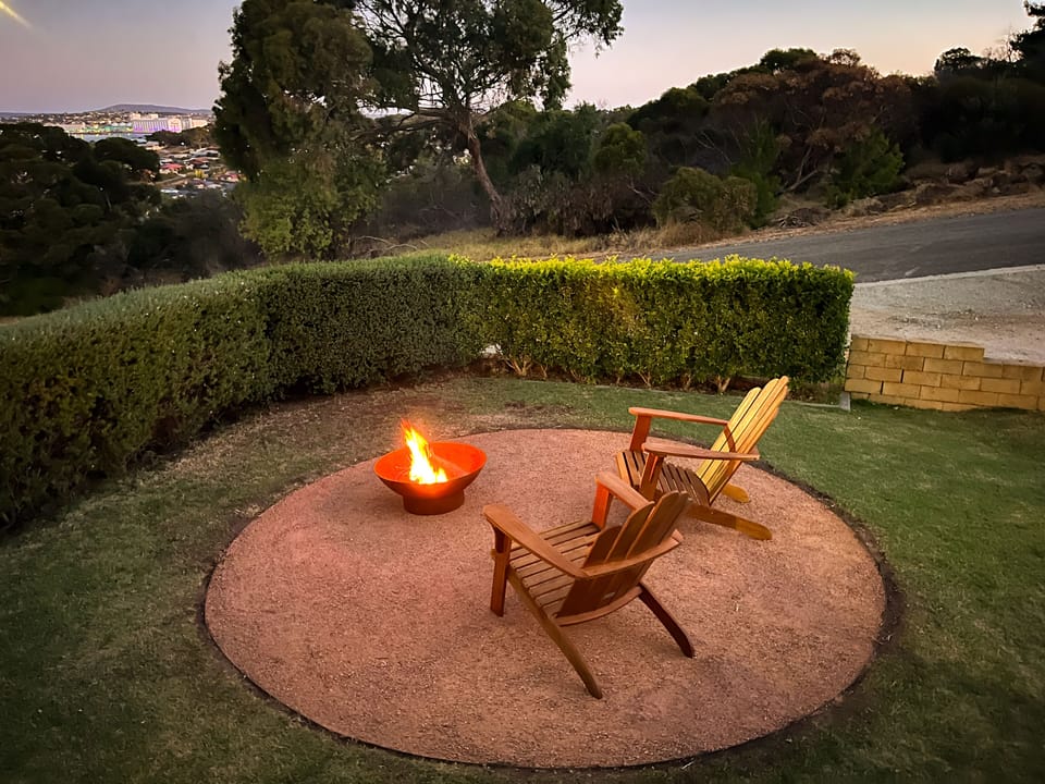 Fire pit entertaining area complete with cape cod chairs.