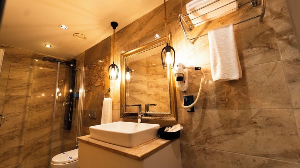 Economy Room, 1 Queen Bed with Sofa bed | Bathroom | Shower, rainfall showerhead, hair dryer, slippers