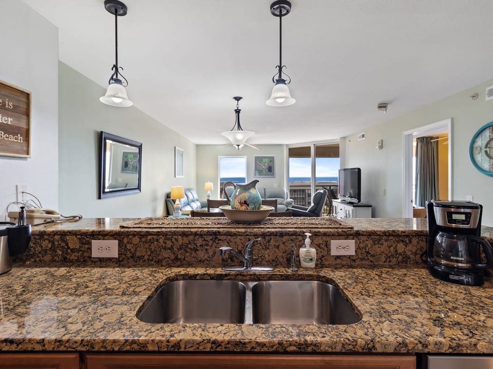 Your granite kitchen island offers stunning ocean views while you prepare meals, with modern appliances and coastal charm.