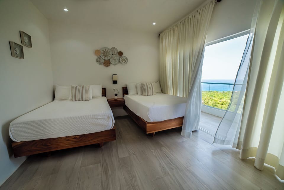 Deluxe Quadruple Room, 1 Bedroom, Non Smoking, Ocean View | Down comforters, pillowtop beds, in-room safe, desk
