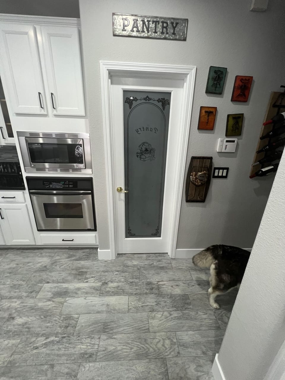 Pantry in kitchen. Microwave and oven.