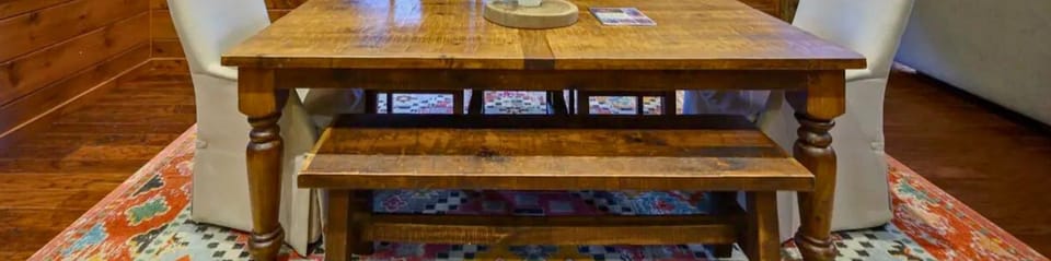 Enjoy memorable meals at this spacious table set against a backdrop of nature.