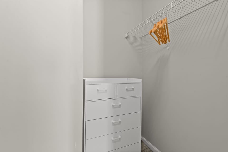 Large closet with dresser and hangers for your folded and hanging items.