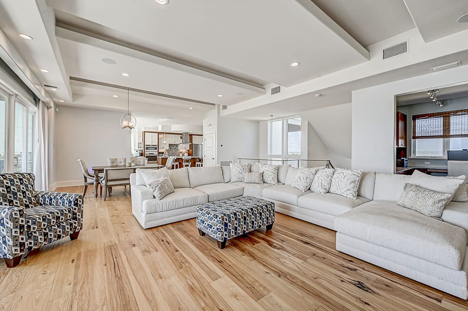 Open-plan living room with cozy seating and a modern kitchen.