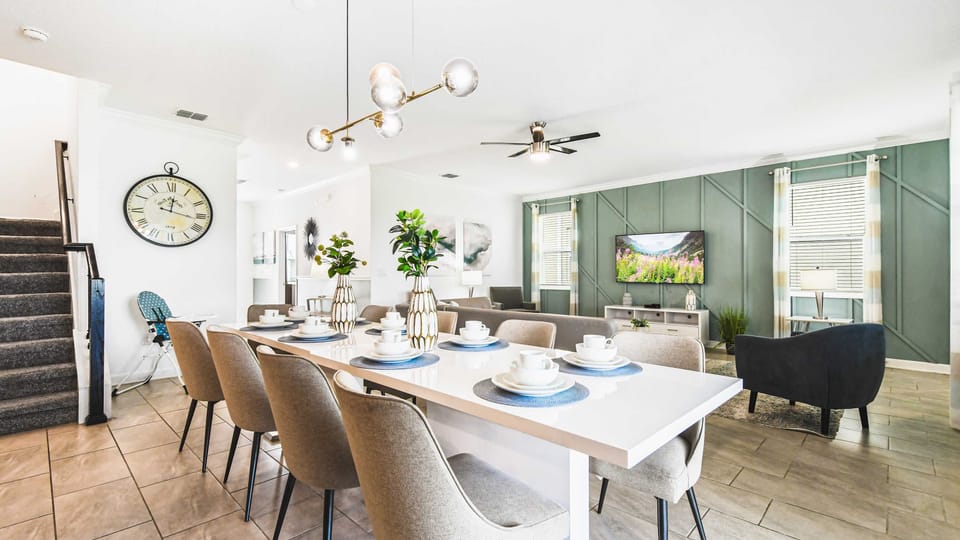 Stylish open dining and living space with modern decor, comfy seating and bright vibe
