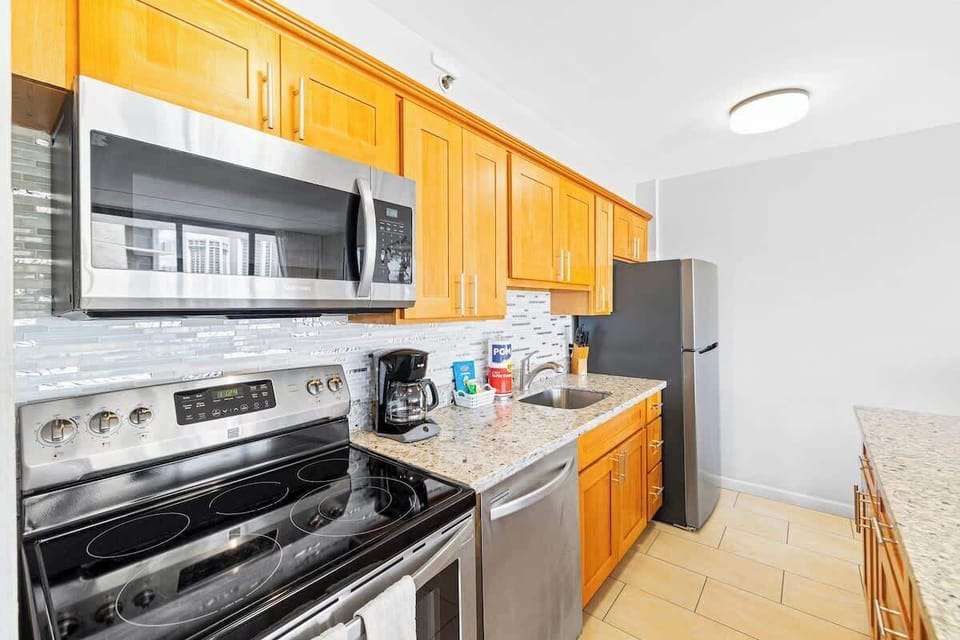 Whip up a delicious meal in your fully-equipped kitchen, featuring modern appliances and ample counter space.