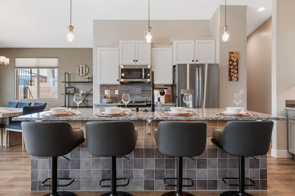 Fully stocked kitchen with bar seating for four.