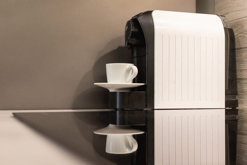 A shelf stocked with coffee cups and essentials, blending practicality with style.

