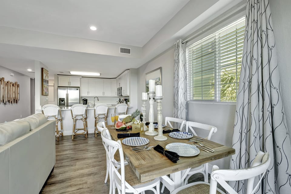 A grand six-seater dining table stands at the heart of this enchanting scene, a testament to both functionality and design.
