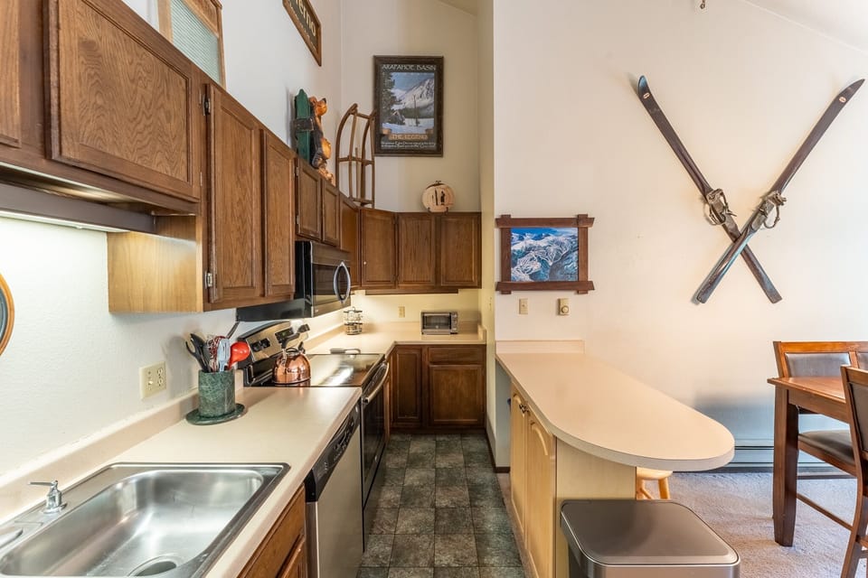 Step into your cozy mountain kitchen, complete with everything you need to whip up hearty meals after adventurous days on the slopes.