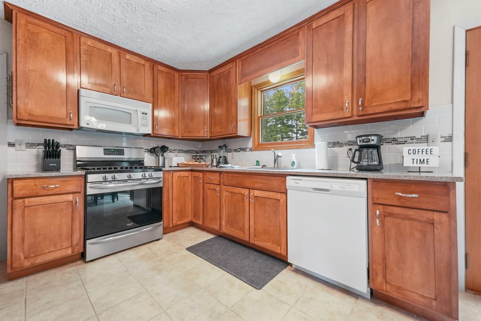 Kitchen: Cook up new memories in this bright space with modern appliances and charming decor!