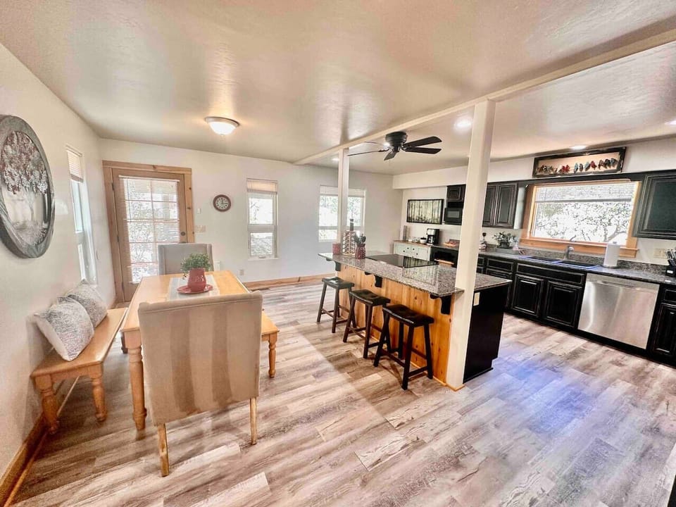 Full kitchen with dining table and door leading to the backyard