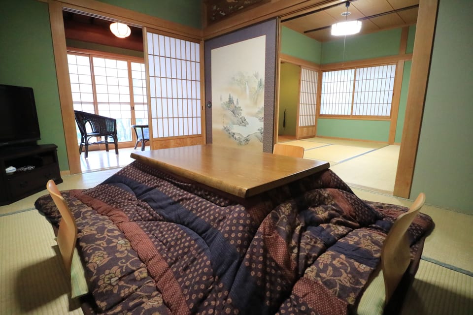 Deluxe Quadruple Room, Non Smoking | Living room | Flat-screen TV
