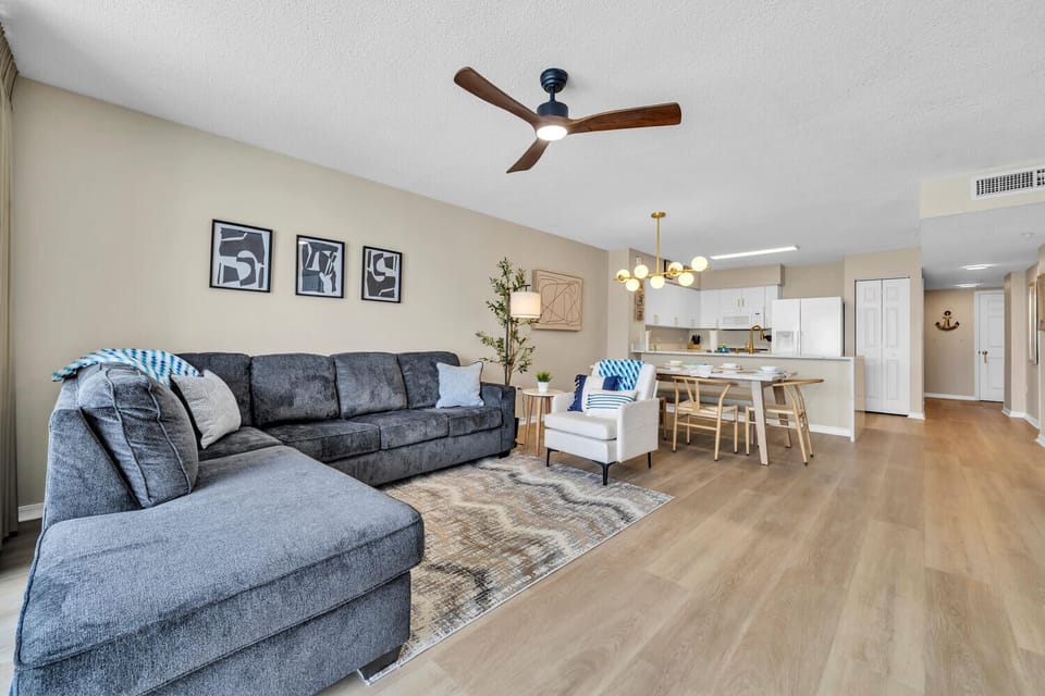 Relax in your spacious living room where ocean breezes flow through soaring windows, revealing turquoise waters from your private balcony.