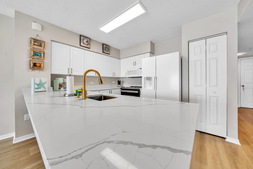 The gourmet kitchen features stunning marble countertops, modern appliances, and a bright skylight creating the perfect space for culinary adventures.