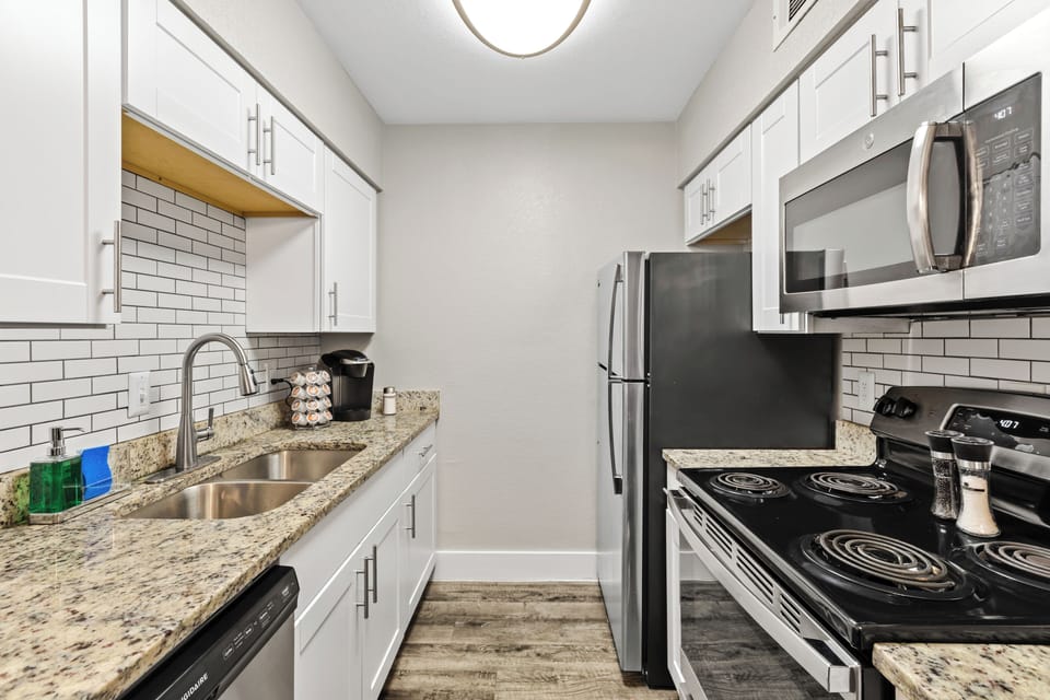 Fully appointed kitchen and with granite counters and stainless appliances