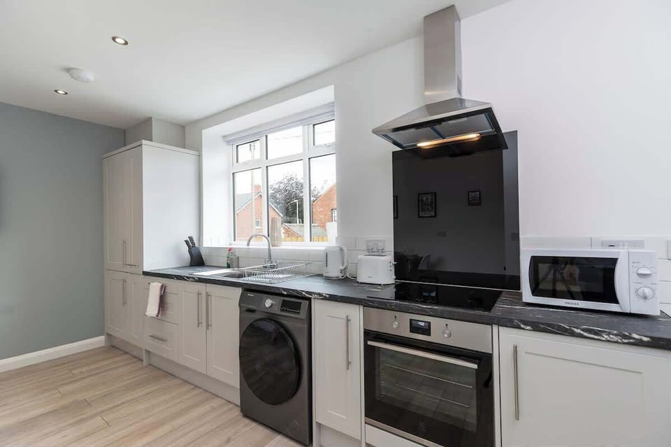 This modern kitchen has everything you need for a hassle-free stay — including a washing machine to keep things clean and convenient
