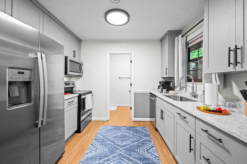 Fully stocked kitchen includes full size electric stovetop, oven, & microwave  