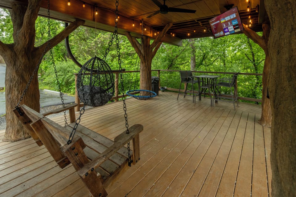 LOWER DECK - SWINGS  - ROPE CLIMB - TABLE TOP SEATING FOR 4 - DRINK CHUTE - 50" TV - ESCAPE HATCH - SECRET LADDER - 20 FOOT SLIDE - BISTRO LIGHTING - OUTDOOR FAN
