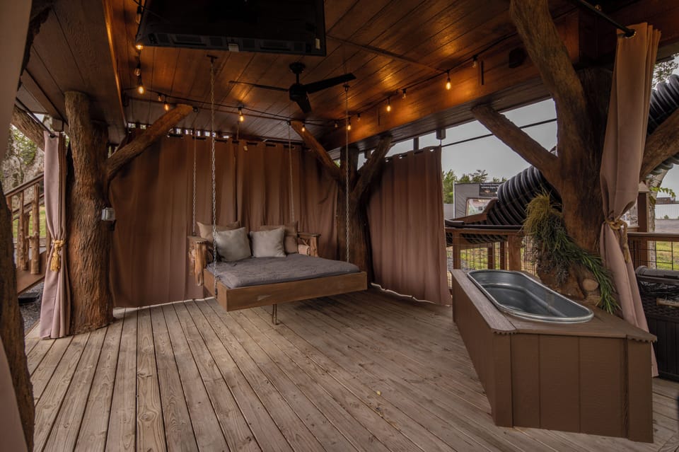 TAKE A NAP ON THE OUTDOOR SUSPENDED DAY BED - PRIVACY CURTAINS - SOAKING TUB - 50" TV - BAR TOP SEATING FOR 2 - BISTRO LIGHTING - DRINK CHUTE 