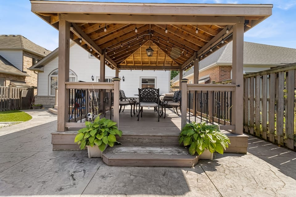 Enjoy relaxing in the backyard oasis with fire pit, BBQ and lots of seating!
