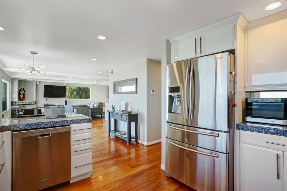 Seamless and spacious this open-concept kitchen, dining, and living area is made for gathering and good times.