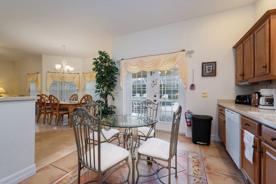 View of dinette from kitchen overlooking the pool