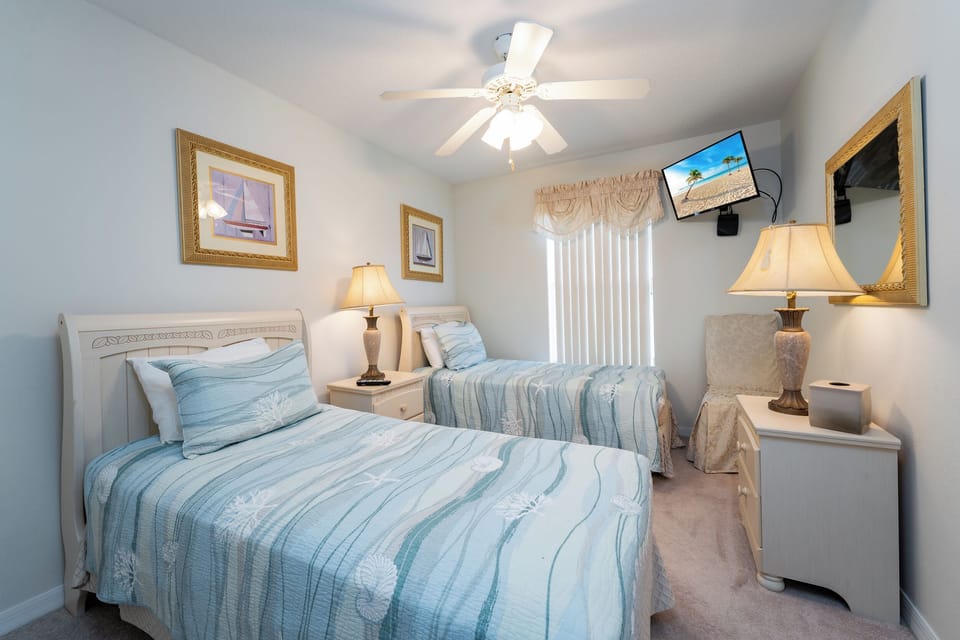 Bedroom 4 with 2 twin beds showing TV