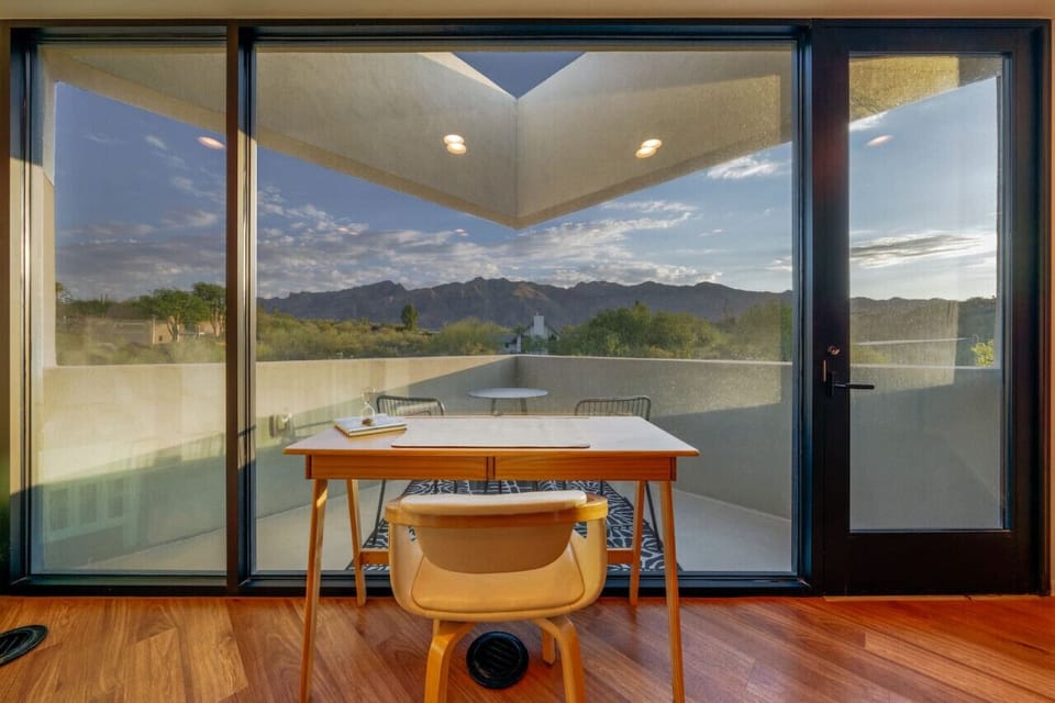 Wow! Bedroom 2`s desk and patio offer stunning mountain views