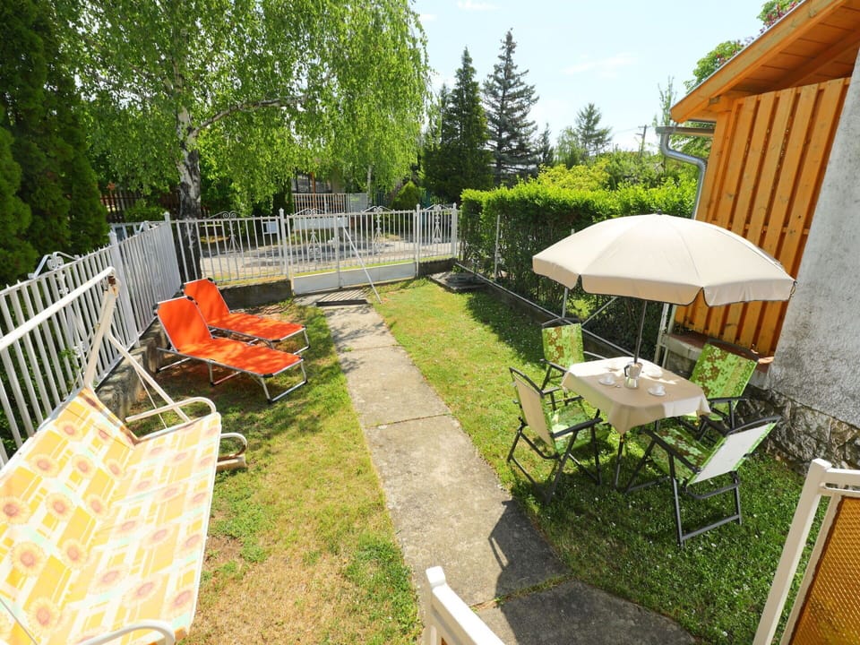 Plant, Furniture, Property, Table, Tree, Chair, Outdoor Table, Outdoor Furniture, Shade, Building