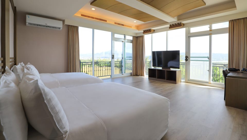Deluxe Quadruple Room | Desk, laptop workspace, blackout drapes, free WiFi