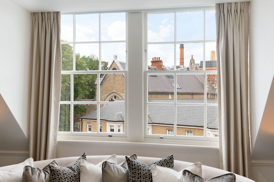 Living room  — enchanting view over the cobbled Pont Street Mews, the Victorian spire of St Saviour`s Church, and the iconic Harrods building beyond