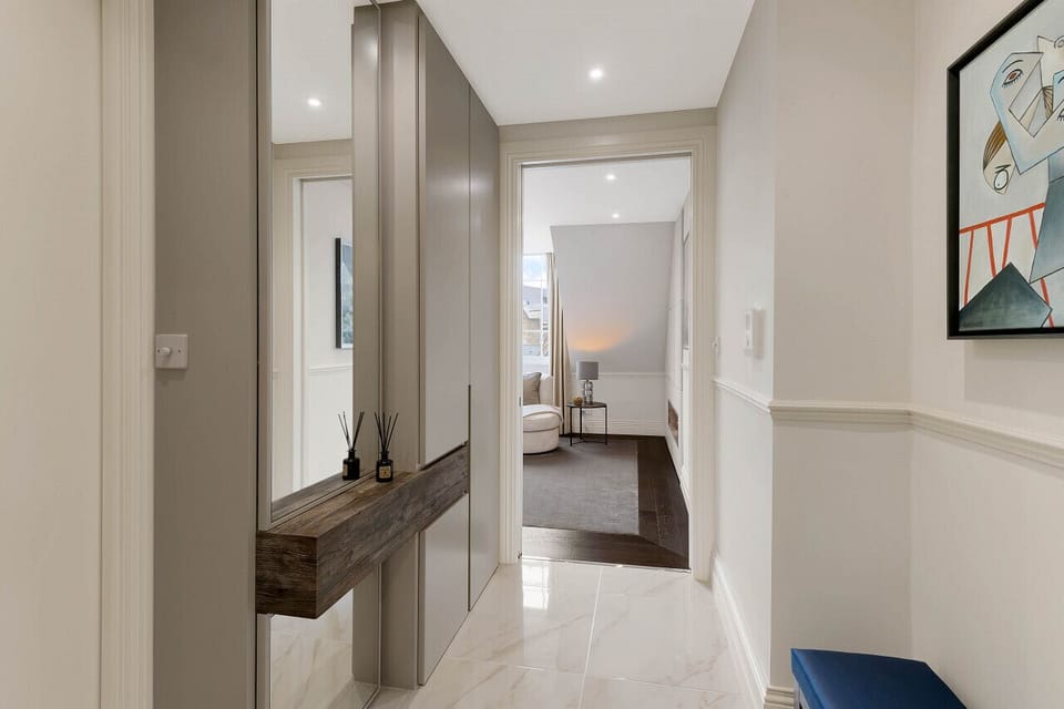 Hallway — tiled flooring with underfloor heating and bespoke entrance unit, leading through to the living room