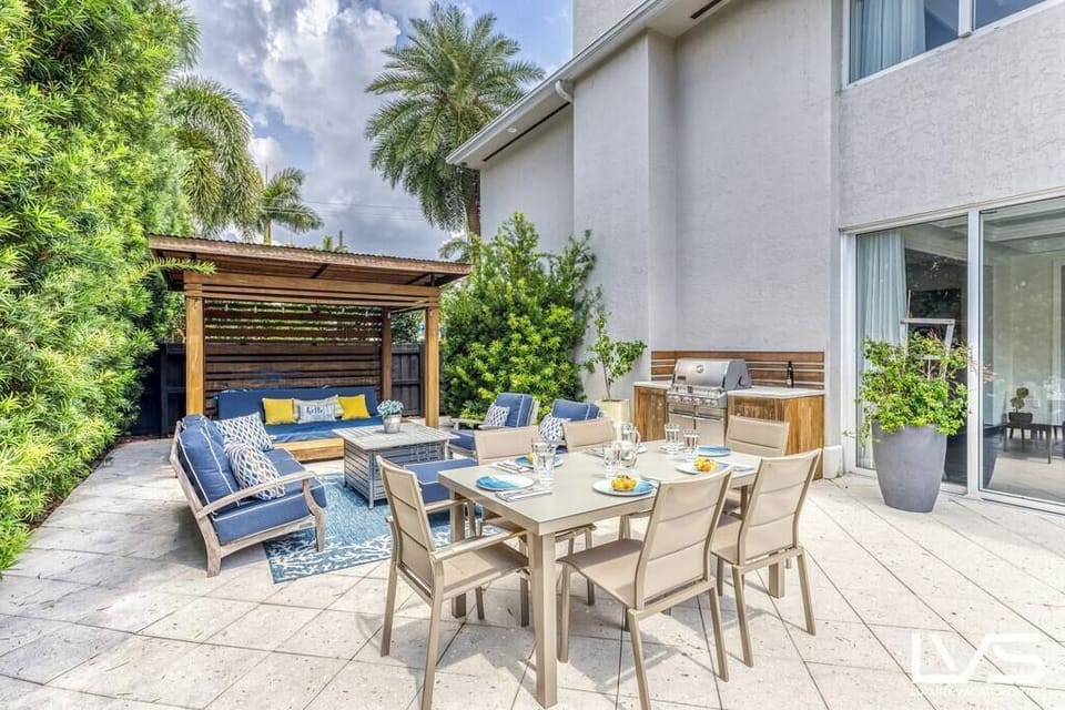 Outdoor patio in Backyard pool area completely private and fenced with lush landscape. 